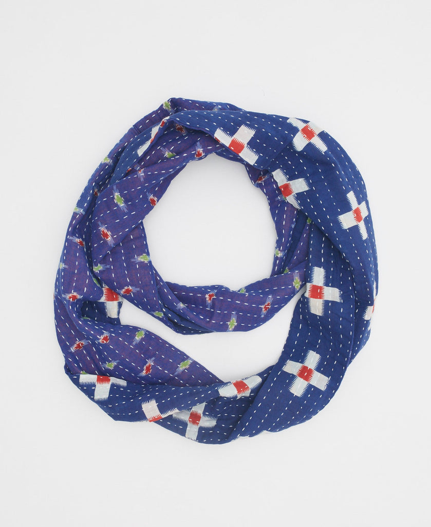 ultramarine blue soft cotton infinity scarf with red, white, and green geometric patterning and white traditional kantha stitching