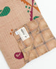 traditional kantha quilt handmade in India with artisan maker signature on the tag
