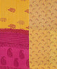 Hot pink and yellow quilt throw featuring contrasting paisley prints