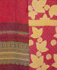 Red and beige artisan made kantha quilt throw featuring a contrasting floral and abstract print 