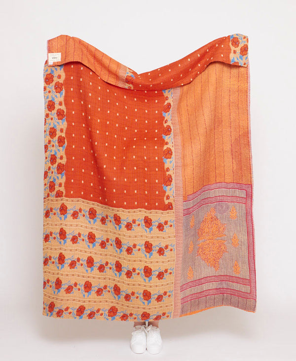 Bright orange handmade large throw quilt created using upcycled vintage saris 