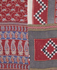 Artisan-made quilt throw featuring contrasting paisley and geometric patterns 