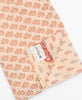 Tag featuring the hand-stitched signature of the maker 