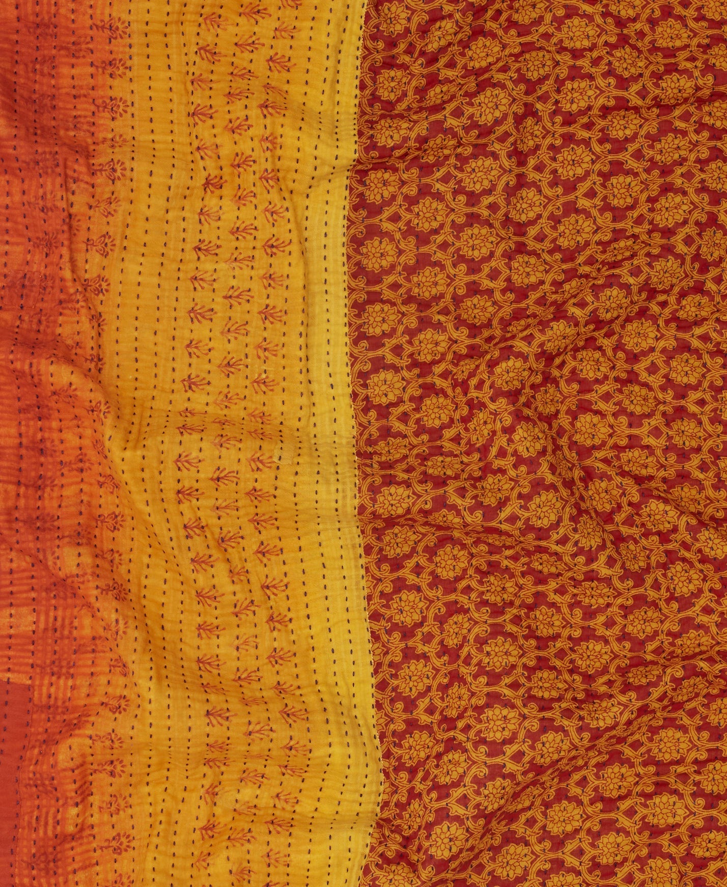 yellow Kantha quilt throw with a tag featuring the hand-stitched signature of the maker