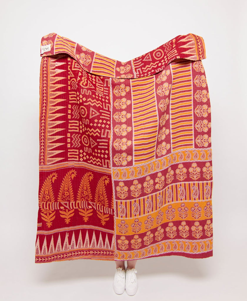 Red, yellow, and orange large throw quilt created using upcycled vintage saris 