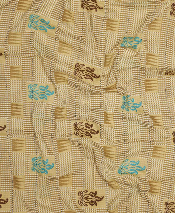 Light brown patterned neck scarf with blue accent designs