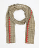 Light green and tan colored cotton scarf that has bold orange accents 