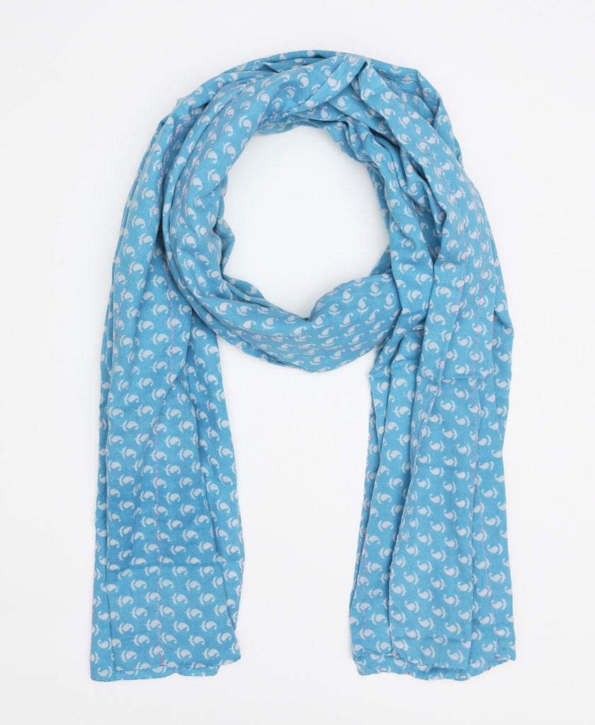 Light blue cotton scarf made from recycled fabrics and has a white paisley pattern