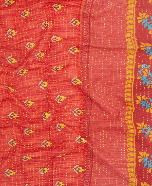 Red and yellow throw blanket crafted using upcycled vintage saris 