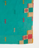 teal artisan made scarf with a pink, yellow, and beige pattern and yellow traditional kantha stitching 