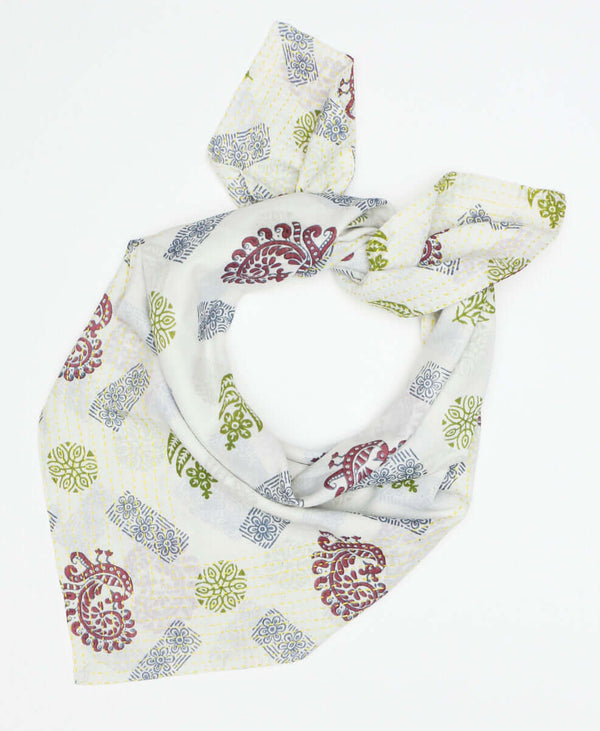 Bright white colored cotton bandana scarf that has unique patterns creating a pop of color 