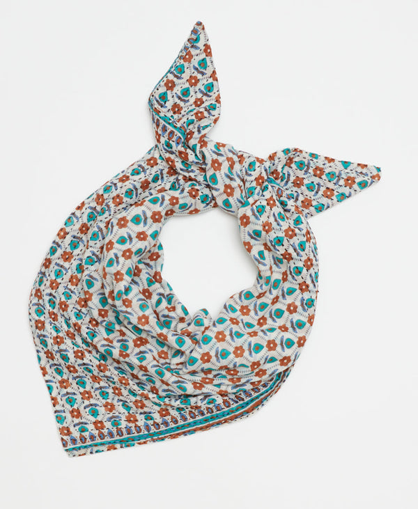 delicate teal and orange floral pattern on a white cotton square scarf made of upcycled vintage saris 