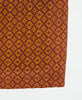 square scarf featuring orange snowflake design with burgundy circles and diamonds with white traditional kantha stitching along all edges of the scarf