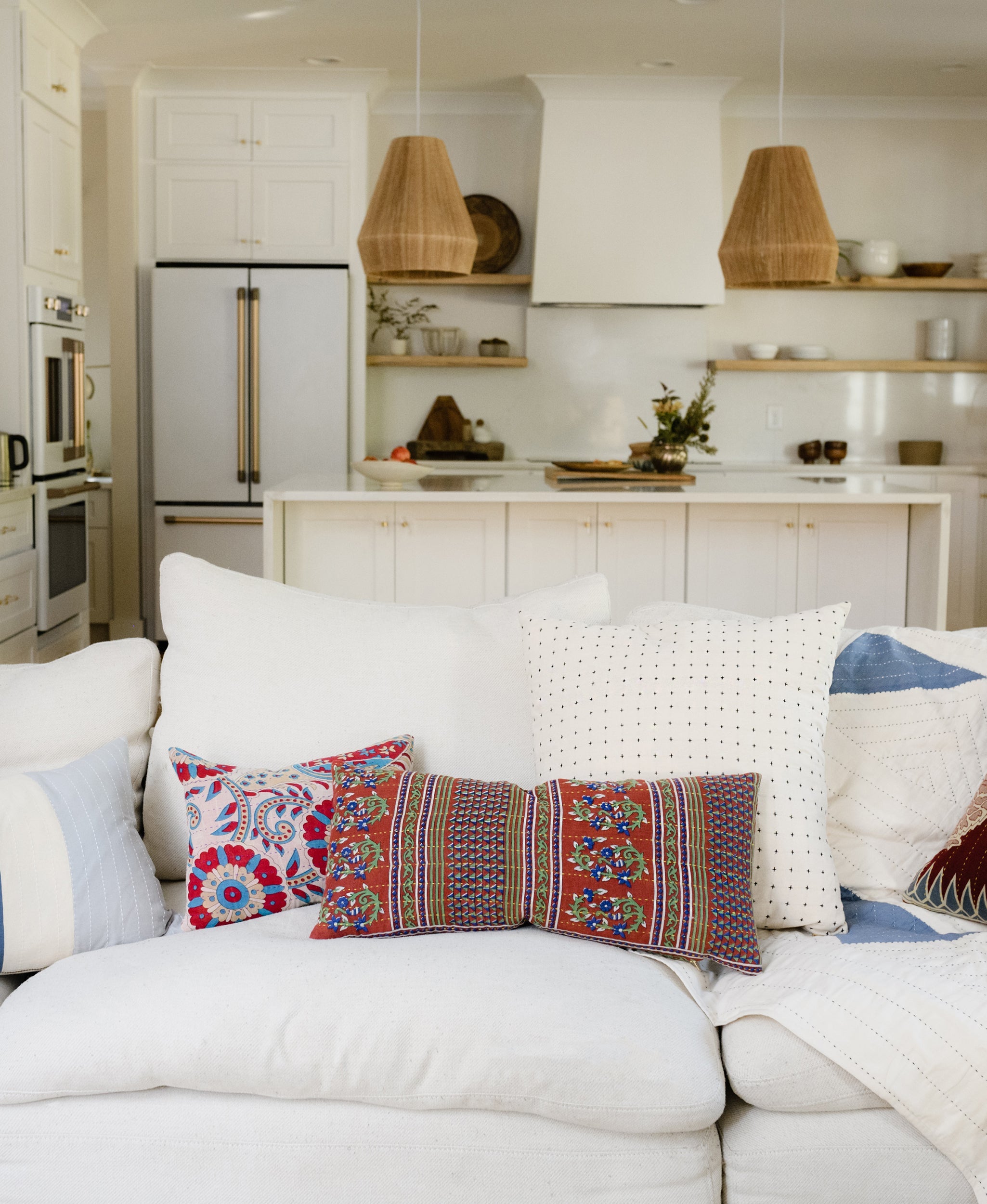 Colorful throw pillows on a white couch 