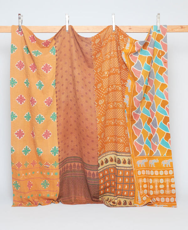 orange mixed pattern kantha quilt handmade in India by a team of all women artisans