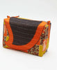 One of a kind sustainable and eco friendly large toiletry bag that has bold patterning in red, orange, and yellow colors