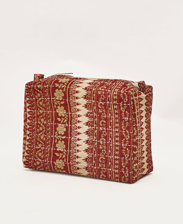 Eco-friendly artisan made toiletry bag featuring a red and tan vintage floral pattern 