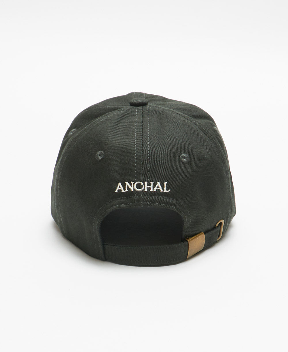 dark green baseball cap with cream embroidered logo on back of hat