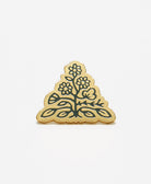 gold triangle shape enamel pin featuring Anchal's logo