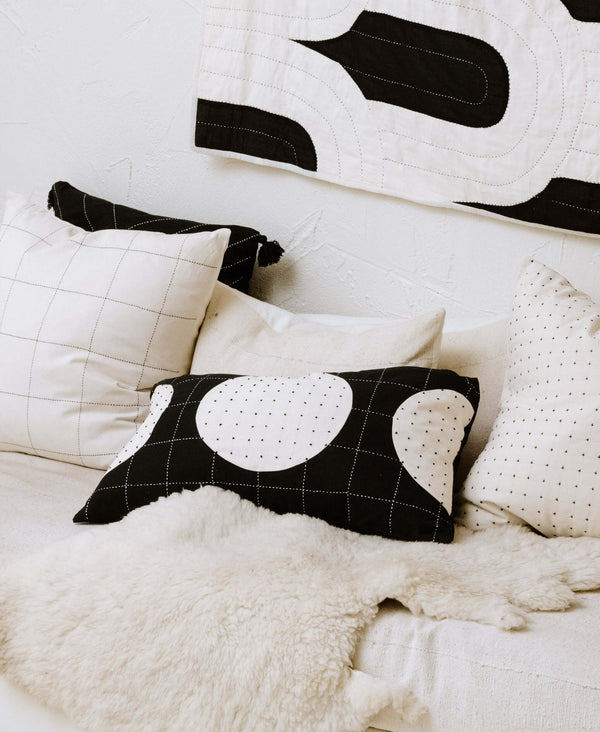 hand embroidered throw pillows  styled on a modern black and white sofa