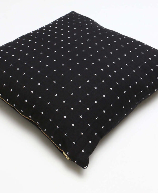 black organic cotton throw pillow with cross-stitch design