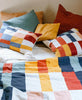 colorful checkered pillows and quilts made form organic cotton hand-embroidered in India