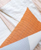 naari colorblock lumbar pillow on grid-stitch throw blanket