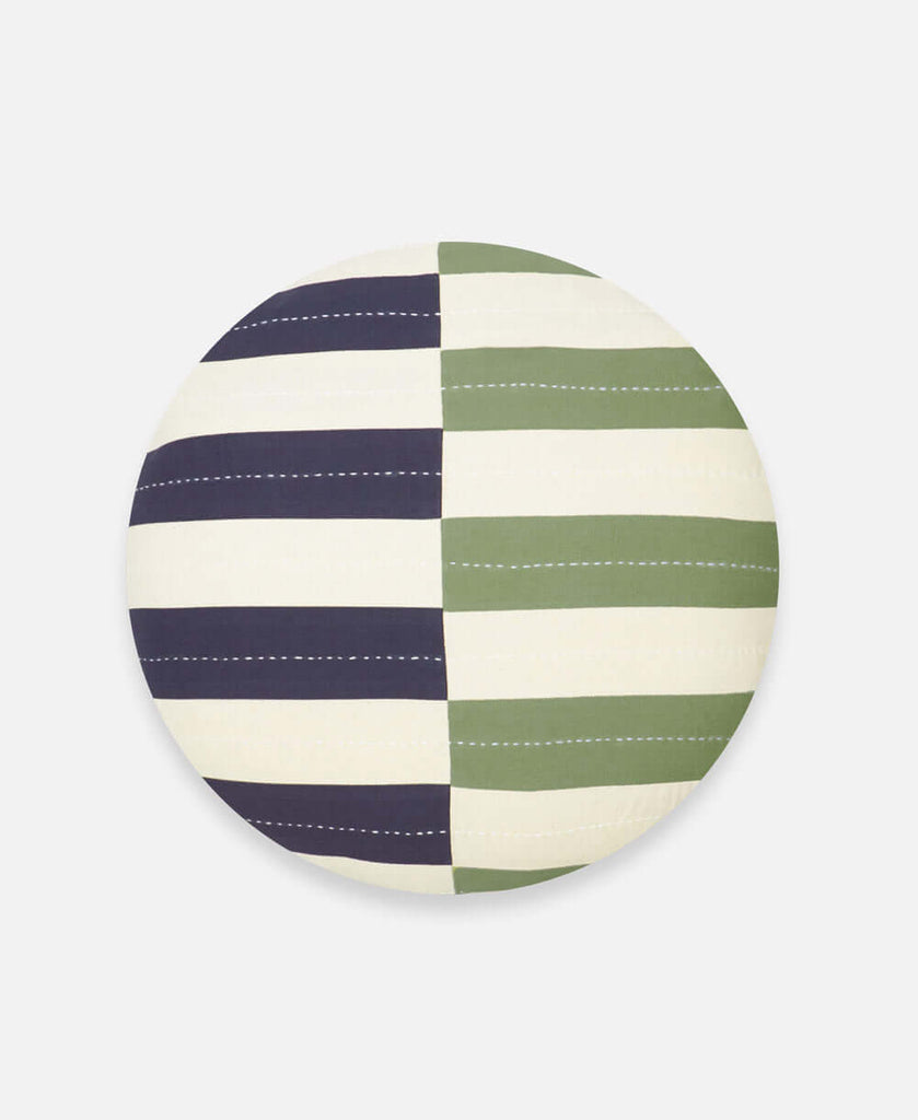 Circular beige throw pillow featuring horizontal leveled navy blue and green stripes
