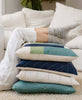 stack of cozy organic cotton pillows in shades of blue, green and ivory by Anchal
