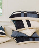 stack of ethically made throw pillows made from GOTS certified organic cotton and AZO free dyes