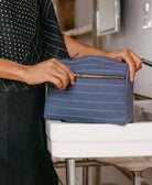 slate blue toiletry bag on a bathroom sink