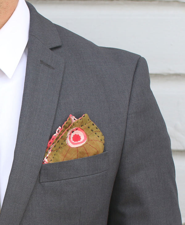 Traditionally patterned pocket square with a mix of paisley patterns paired with a men's jalcket