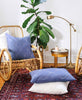 bamboo wicker chair styled with boho home decor and organic cotton pillows