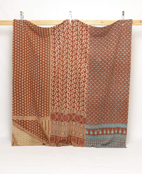 One of a kind vintage quilt featuring cream and burnt orange designs 