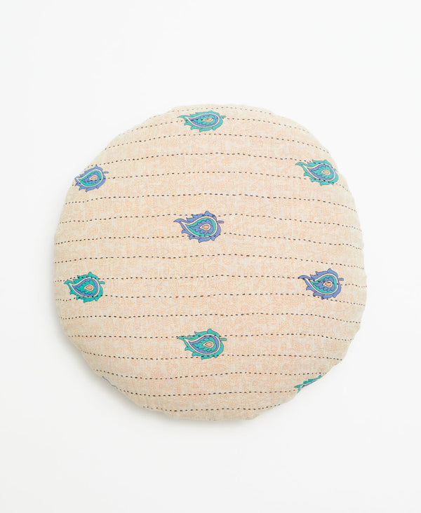 Cream round vintage kantha throw pillow featuring a large yet minimal purple and blue paisley pattern through out 