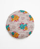 Grey round vintage kantha throw pillow featuring a teal, yellow, and magenta floral pattern  
