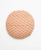 Opposite side of pillow featuring a red design on a tan background 