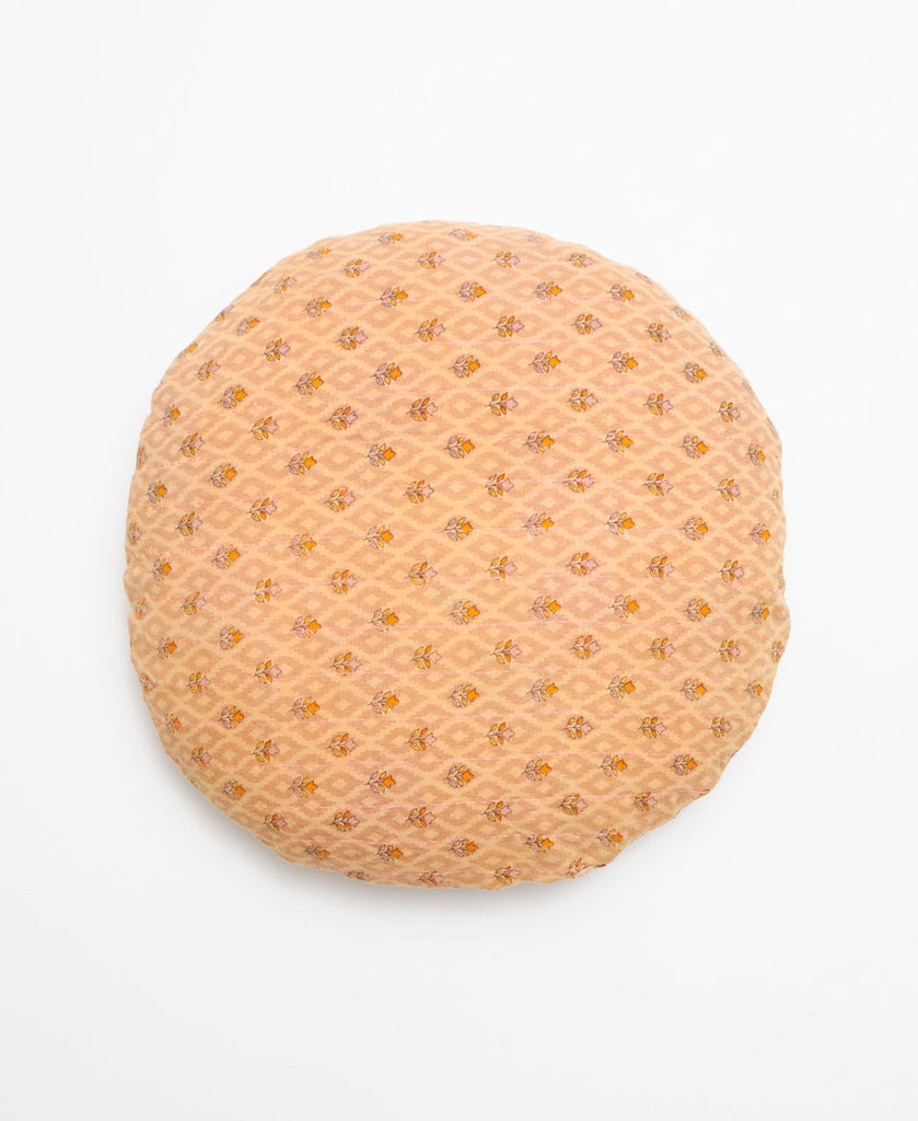 Beige round vintage kantha throw pillow with a minimal mustard floral pattern through out 