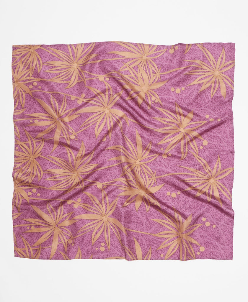 Handcrafted silk square scarf with a purple background and a large tan floral pattern 