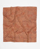 Handcrafted silk square scarf with a black abstract print on a rich tan background 