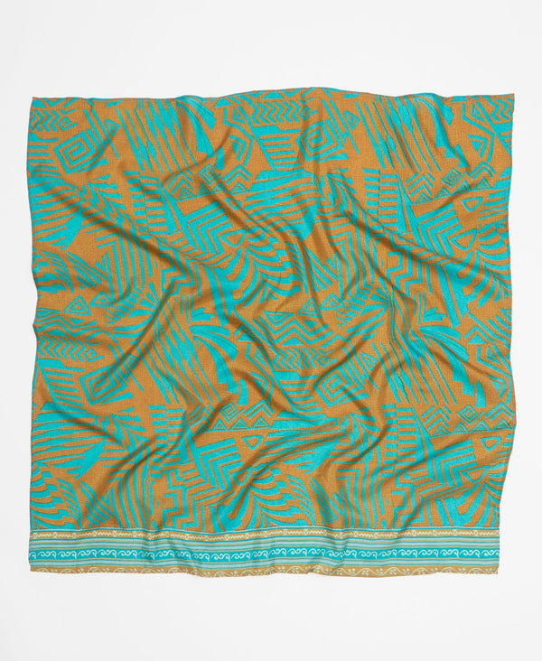 Teal and brown silk square scarf featuring a large graphic print 