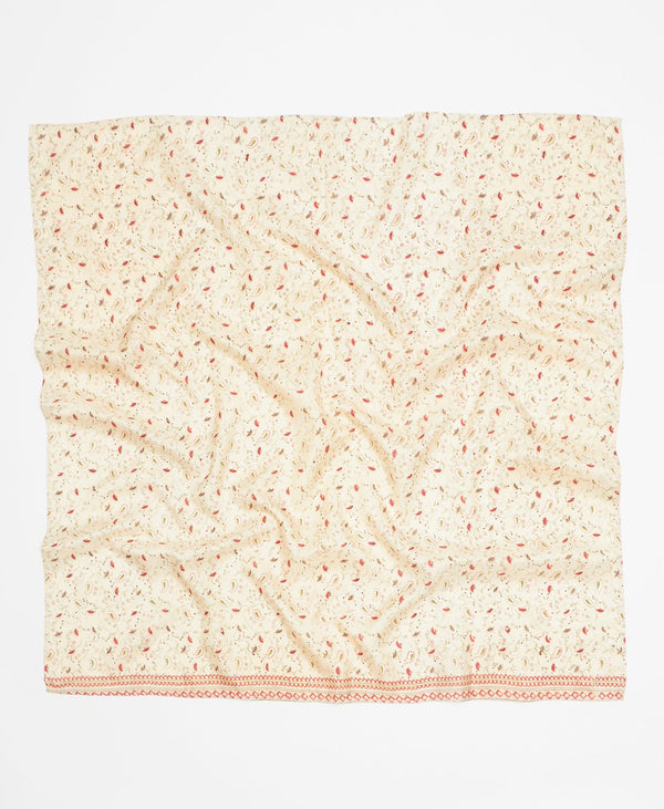 Cream silk square scarf featuring a small red and green print through out 