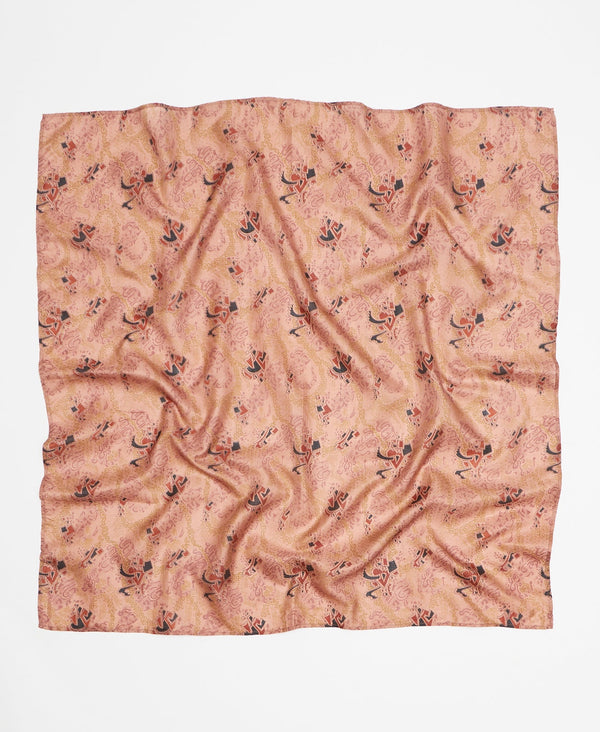 Peach silk square scarf featuring a black and brown abstract pattern 