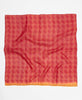 Vibrant red silk square scarf featuring an orange accent around the edge 
