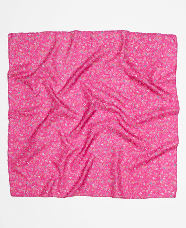 Hot pink silk square scarf featuring a small white and blue floral patern through out 