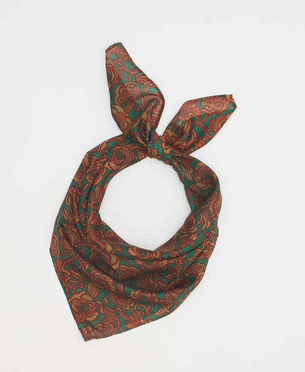 emerald green silk square scarf featuring  a golden and red floral pattern 