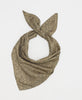 Beige silk square scarf featuring an intricate black paisley pattern 