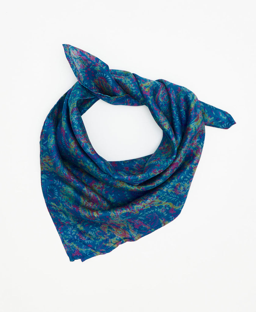 bright blue silk bandana with small green and purple floral details 