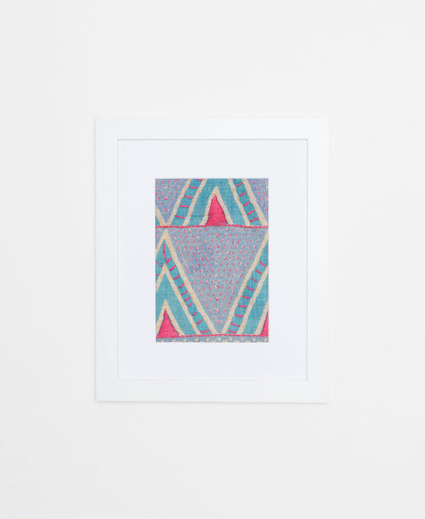 Handcrafted framed Artisan artwork featuring a pink and teal geometric pattern. 