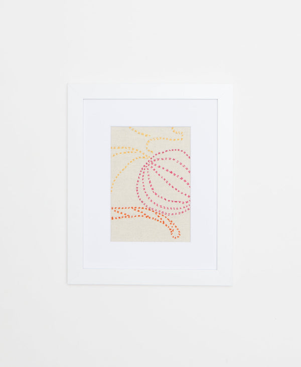 Handcrafted Artisan textile framed artwork featuring pink, yellow and orange stitching on a white background 